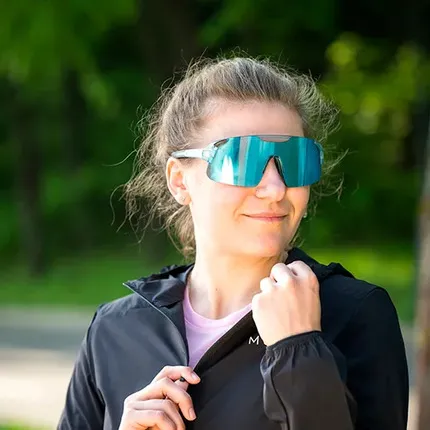 Девушка в очках и куртке компании MOAX.