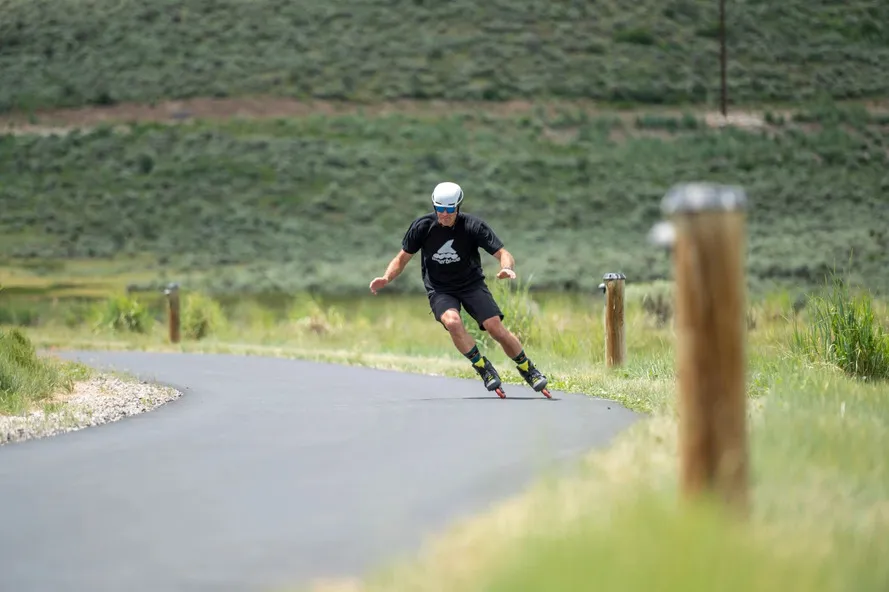Мужчина катается по дороге на роликовых коньках компании Rollerblade